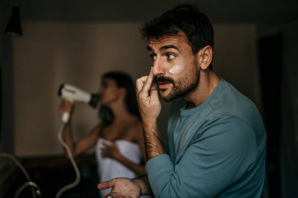 Intimate bathroom moment captured as a multicultural couple shares their morning routine