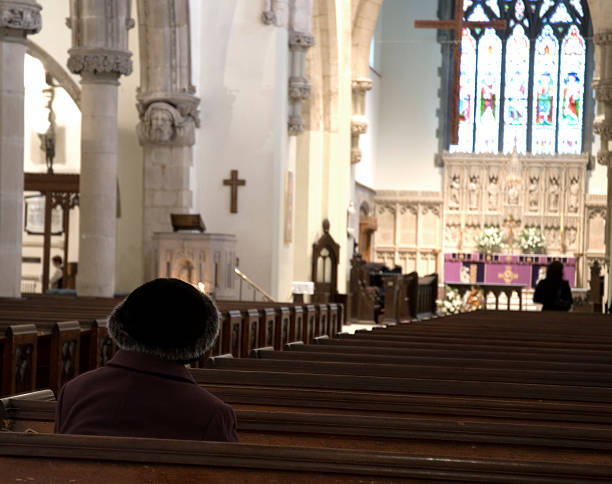 istock Old woman praying in a church 172188034
