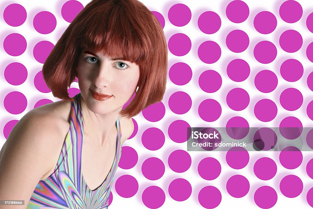 Look Here! A redhead poses in front of an attention grabbing background. Adult Stock Photo