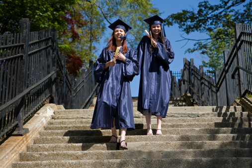 Two girls after graduation on stairs