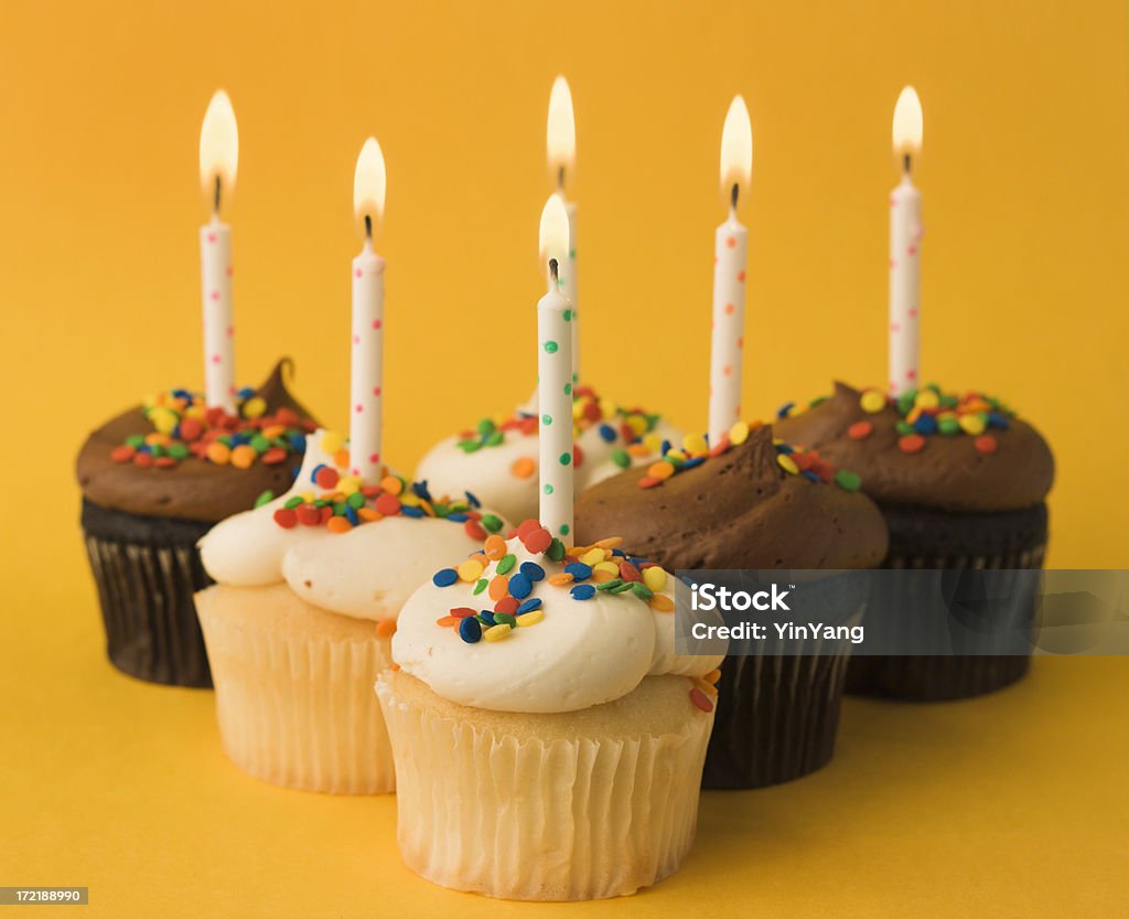 Happy Birthday Cupcakes Subject: A display of cupcakes with colorful sprinkles and confetti with birthday candles Anniversary Stock Photo