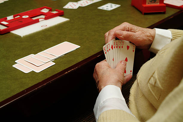 Hands of senior woman Playing Cards stock photo