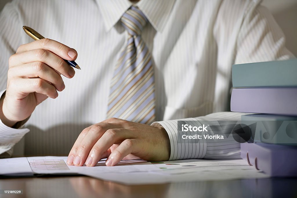 Business notes Close-up of a businessman writing something. Shallow depth of field - focus on hands. Adult Stock Photo