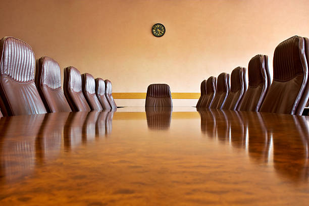 At the meeting room Meeting room with a big polished table and arm-chairsOther photos from this business series: conference table stock pictures, royalty-free photos & images