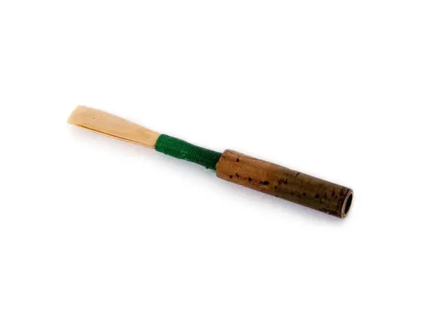 This is an oboe reed showing the cane, green thread, and cork covered brass tube. See my other images of the oboe to understand how it figures as the instrument's mouthpiece. Oboe players actually make these themselves from scratch, trimming the cane, tying it onto the tube, and then carving and scraping it carefully until the tip is as thin as can be. Then they have to do it all over again a few weeks later. This is one reason there are not a whole lot of oboe players. Definitely.