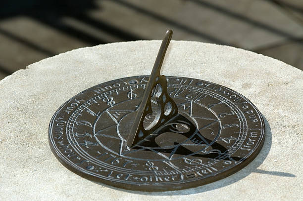 SunDial A Sundial on a Stone platform. vertical sundial stock pictures, royalty-free photos & images