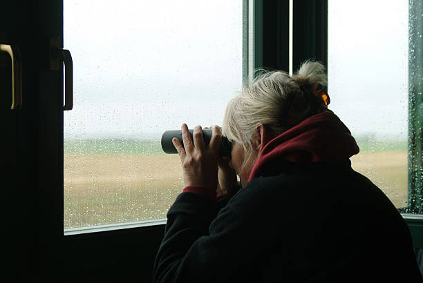 Senior woman birdwatching stock photo