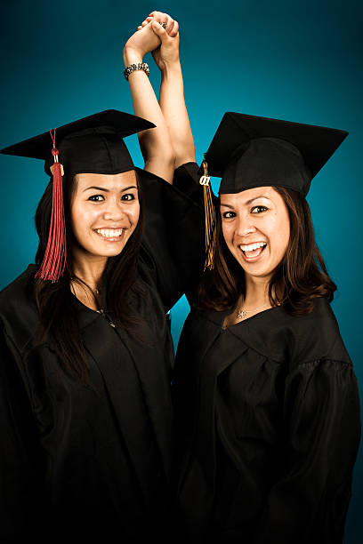 istock graduation girls with hands up 172190063