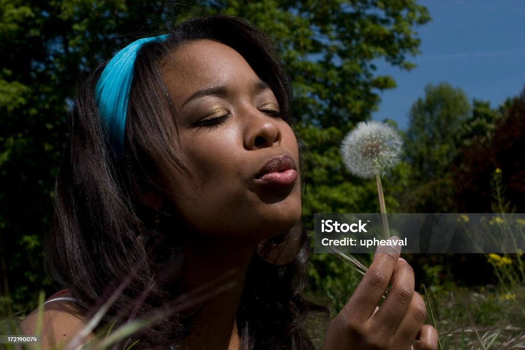 Wild Grass Series Young Black woman makes a wish on a sunny summer day. 20-29 Years Stock Photo