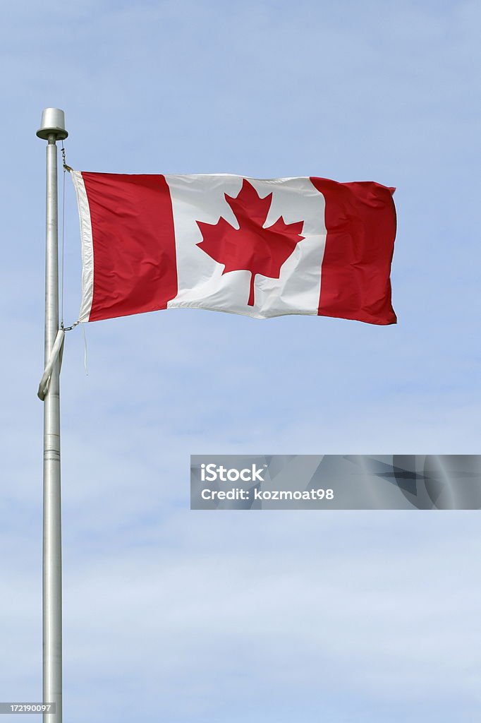 Canadian Flag - 2 Canadian flag on a pole against a blue sky. Canadian Flag Stock Photo