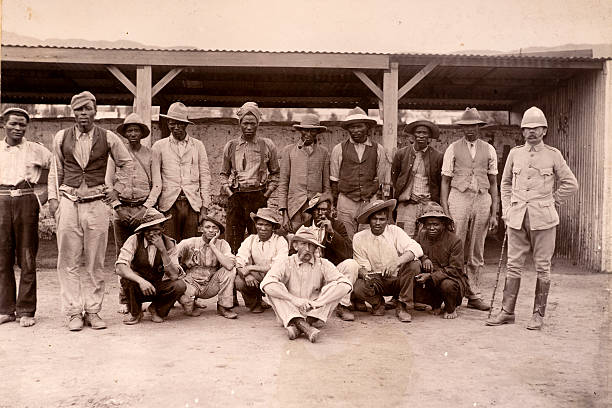 African auxiliaries "Vintage photograph of African auxiliaries employed as wagon drivers etc, by the British in the Boer war.   A British officer stands to the side of them." wild west photos stock pictures, royalty-free photos & images
