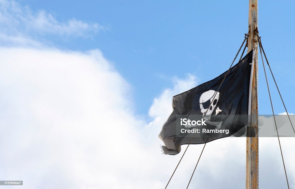 Piracy Jolly Roger in the mast of a pirate ship. Ghost Ship Stock Photo