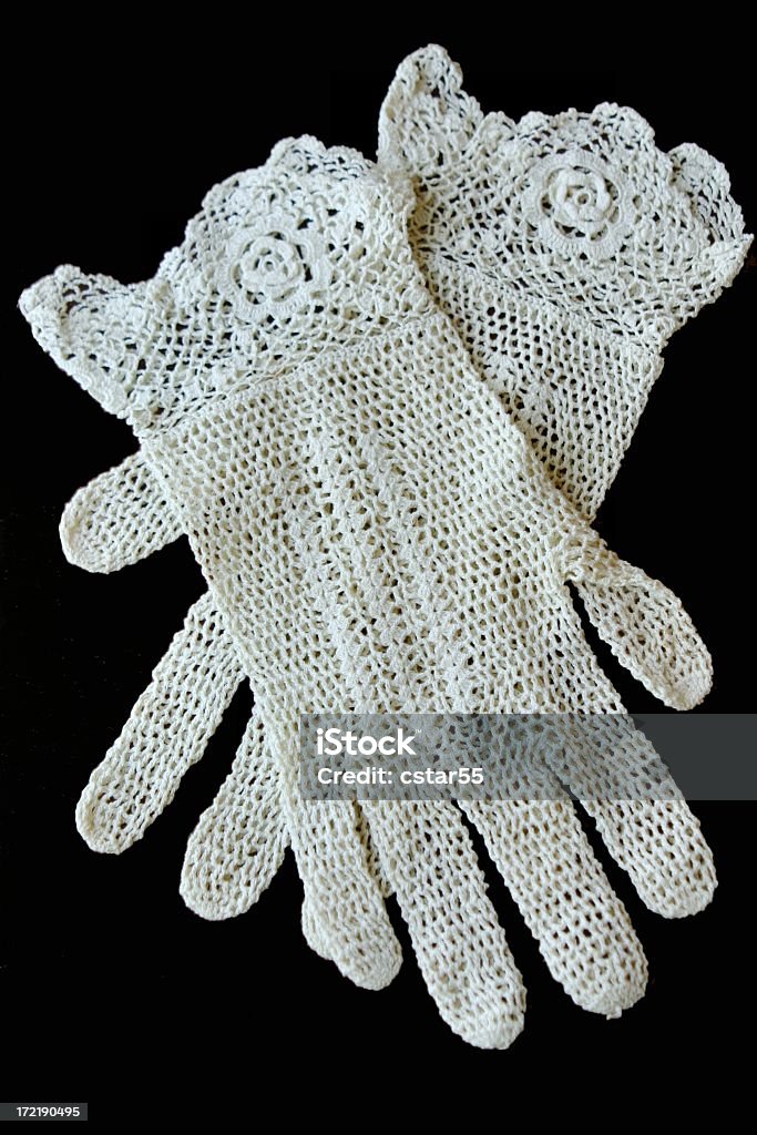 Antique Crocheted Gloves on black background Antique or Old crocheted gloves on black background. Vertical image. Glove Stock Photo