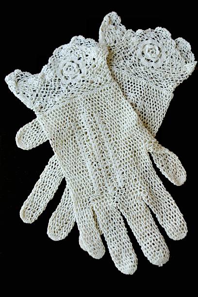 Antique Crocheted Gloves on black background stock photo