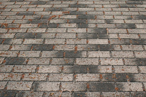 Weathered shingle roof that needs replacing.