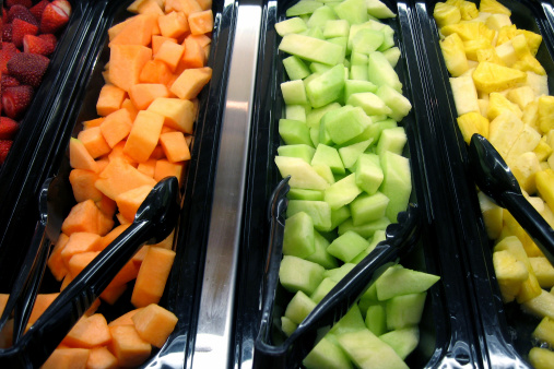 A selection of fruit on a salad bar.