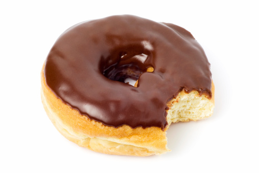 A chocolate covered doughnut with a bite taken from it.  Isolated on white with soft shadow.