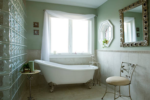 bathroom An elegant bathroom with a clawfoot tub. The artwork has been blurred out. free standing bath photos stock pictures, royalty-free photos & images