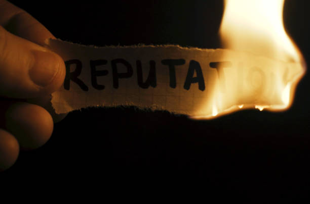 istock A man burns paper with the inscription - Reputation 1721922400