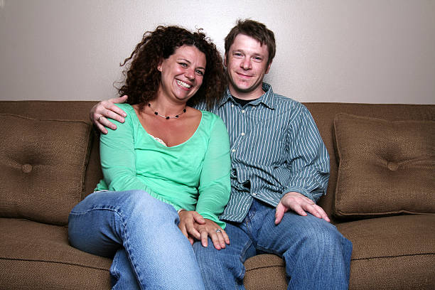 istock happy couple on couch 172192446