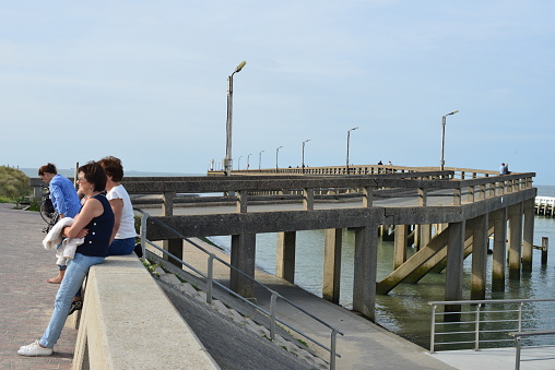 Blankenberge, West-Flanders, Belgium-September 30, 2023: A pair of white older women, in their sixties visit the observation point of the World War II German bridge after the announcement that the pier will be demolished