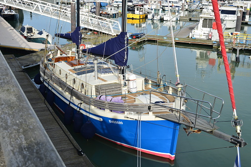 Blankenberge, West-Flanders, Belgium-September 30, 2023: moored classically larger blue sailing yacht with flexible thin solar panels on the roof in the Blankenberge marina