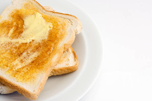 istock Buttered toast on a white plate against a white background 172193166