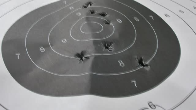 Bullet-Riddled Paper Shooting Target Close-Up