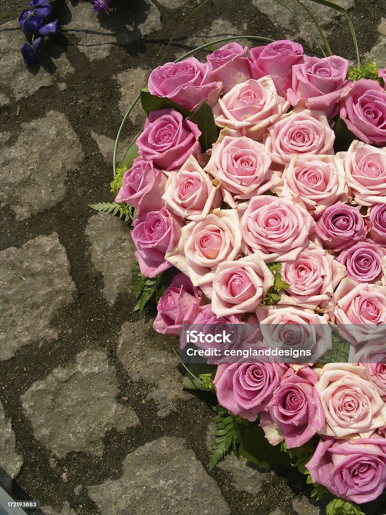 Heartfelt Roses Light and dark pink roses clustered into a heart bouquet on cobblestone; features left half of heart - perfect for Valentines Day or similar special occasions. Bouquet Stock Photo