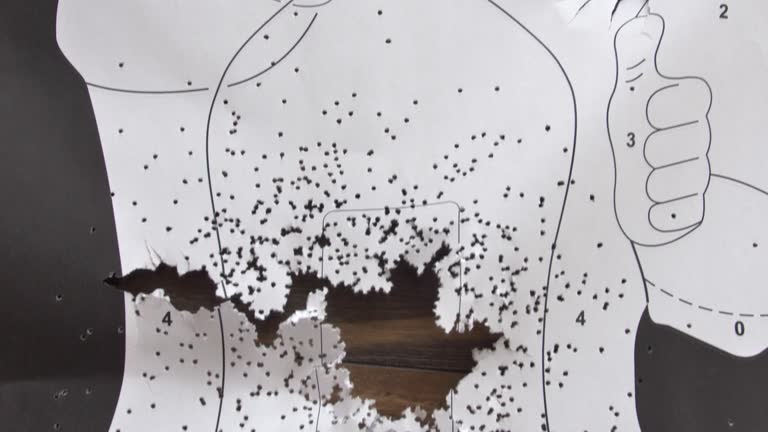 Bullet-Riddled Human Silhouette Paper Shooting Target Close-Up