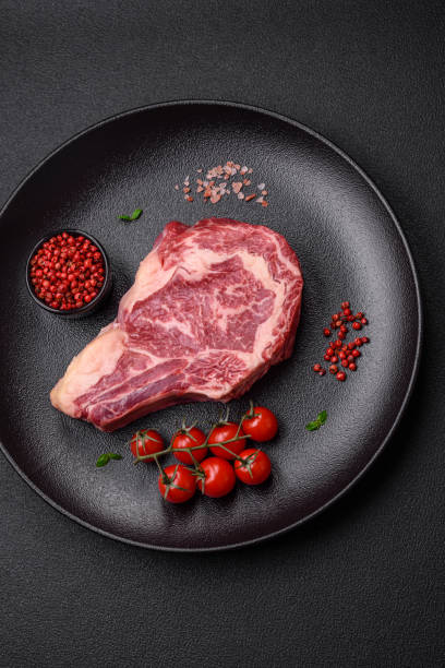 istock Fresh juicy raw beef striploin steak with salt and spices 1721940302