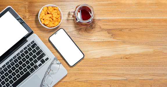 Flay lay, Top view office table desk with smart phone, keyboard, coffee, pencil, leaves with copy space background.