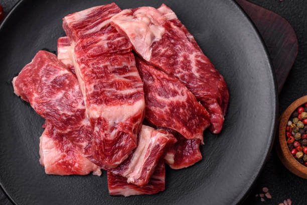 istock Fresh juicy raw beef slices with salt and spices 1721944273