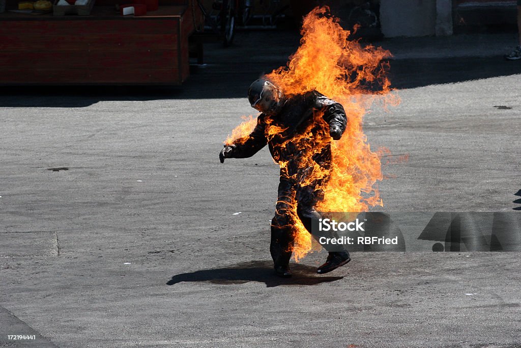 Man in a protective suit wrapped in flames a man on fire Fire - Natural Phenomenon Stock Photo