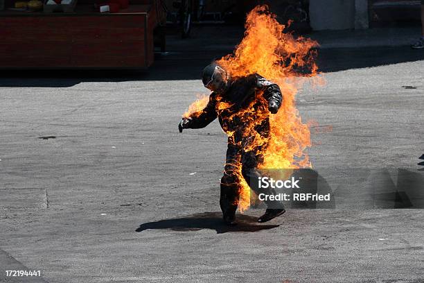 Man In A Protective Suit Wrapped In Flames Stock Photo - Download Image Now - Fire - Natural Phenomenon, Stunt Person, Men