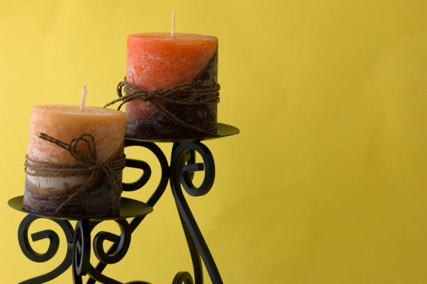 istock Beautiful candles on yellow background 172194567