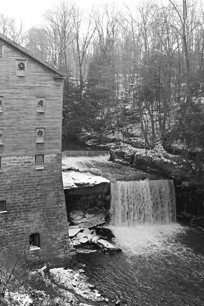 Water Falls At Lanterman's Mill - Youngstown, Ohio "Water Falls At Lanterman's Mill.  Mill Creek Park, Youngstown, Ohio.  Monochrome, with an old feel. Winter scene with some snow.See more of my" youngstown stock pictures, royalty-free photos & images