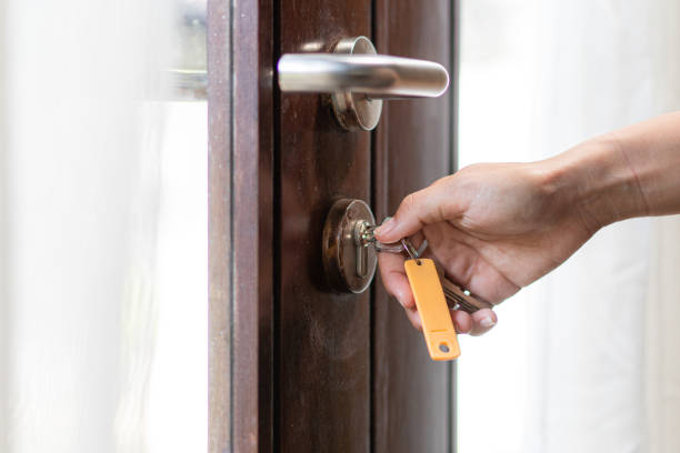 istock Close up hand holing key lock the door 1721945982