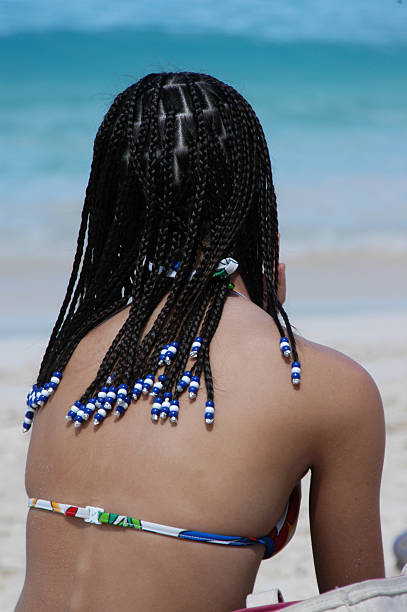 beach bum - braids human hair swimming island стоковые фото и изображения