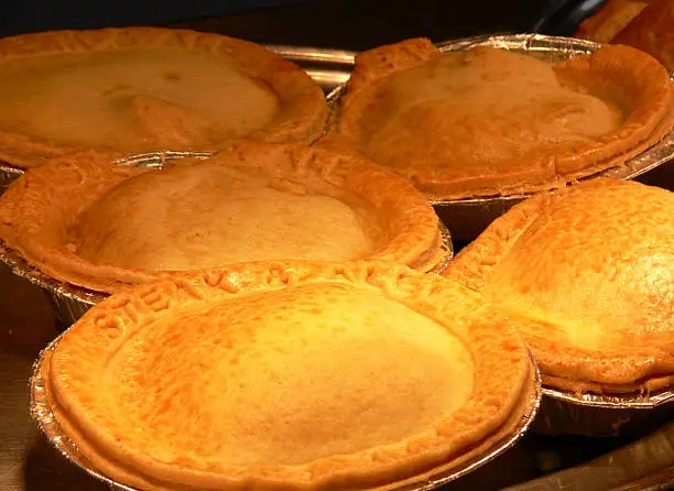 Pies with 'Steak and Ale' embossed into the pastry.