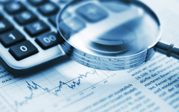 istock Magnifying glass on financial chart 1721964298