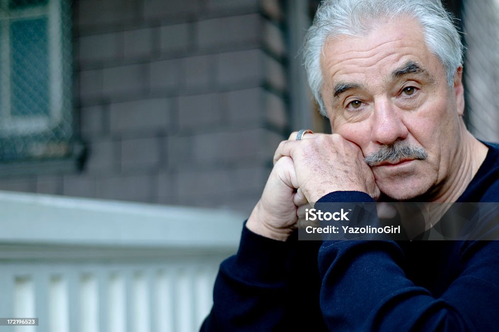A man which a facial expression asking why "Senior man in grief... shows wedding ring on left hand. Husband, fatherLow depth of field.Focus on hand with wedding ring and eyes." Sadness Stock Photo