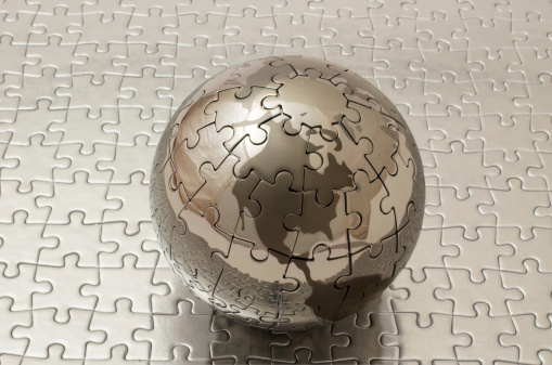 silver jigsaw globe on silver flat jigsaw
