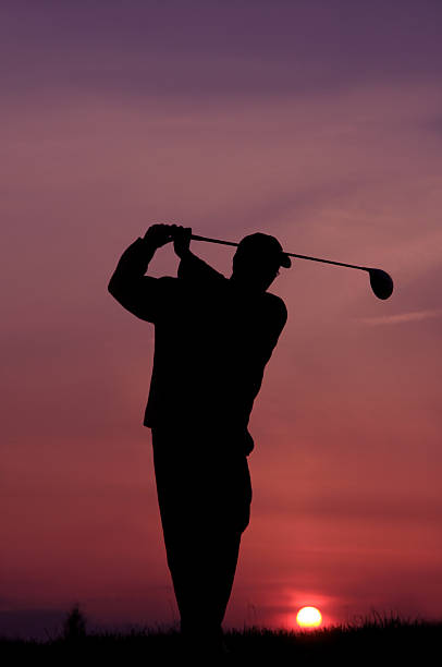 Golfer Silhouette A golfer at dusk. night golf stock pictures, royalty-free photos & images