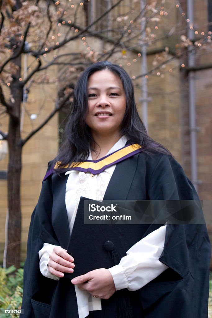 Graduation Day student Graduation Day at Manchester University with Asian student in formal gown. Graduation Stock Photo