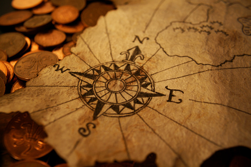 A compass on an old pirate map.