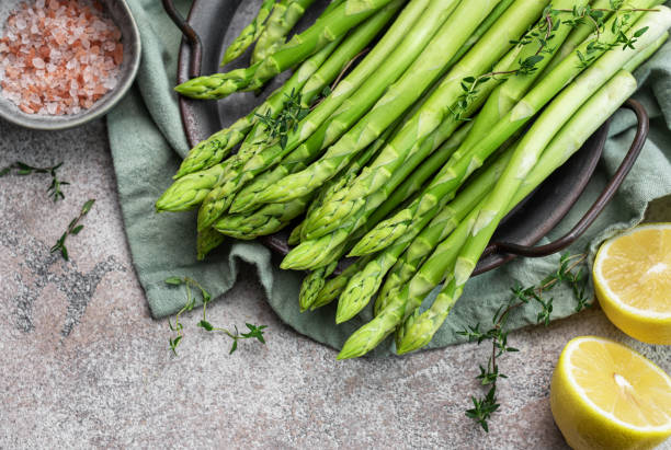 istock Bunch of raw asparagus stems with different spices 1721978884