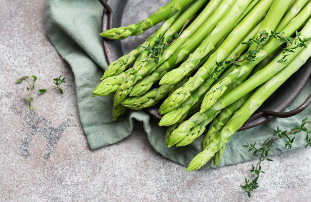 istock Fresh green asparagus on  concrete background. 1721978887