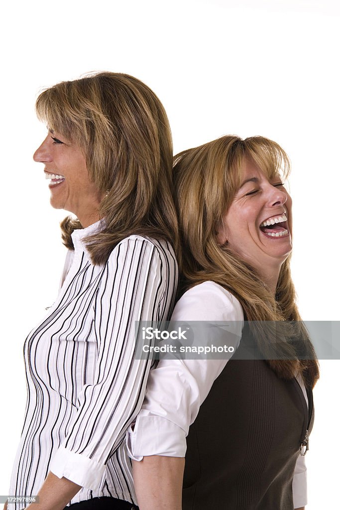Laughing two woman back to back. Back To Back Stock Photo