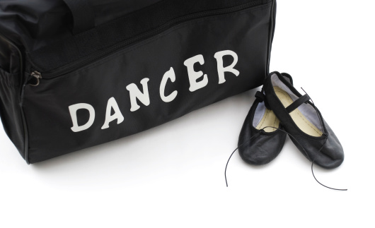 Ballet dancer's equipment; dance bag and ballet shoes. Room for writing.